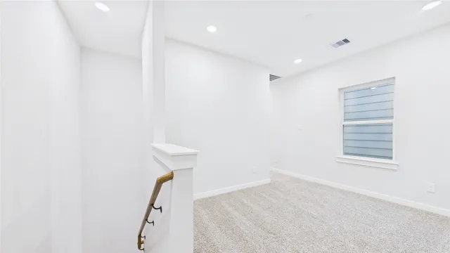 a bedroom with a bed a chair and potted plant