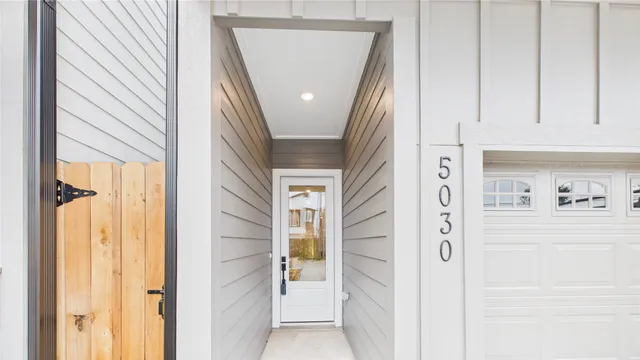 a view of hallway with wooden floor