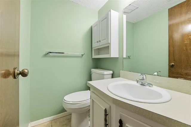 a bathroom with a sink a toilet and mirror