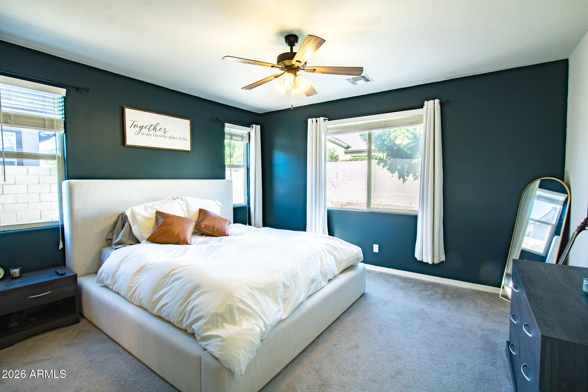 20378 West Maiden Lane Buckeye, AZ 85396 - Photo 23 of 41 a bedroom with a large bed and a chandelier