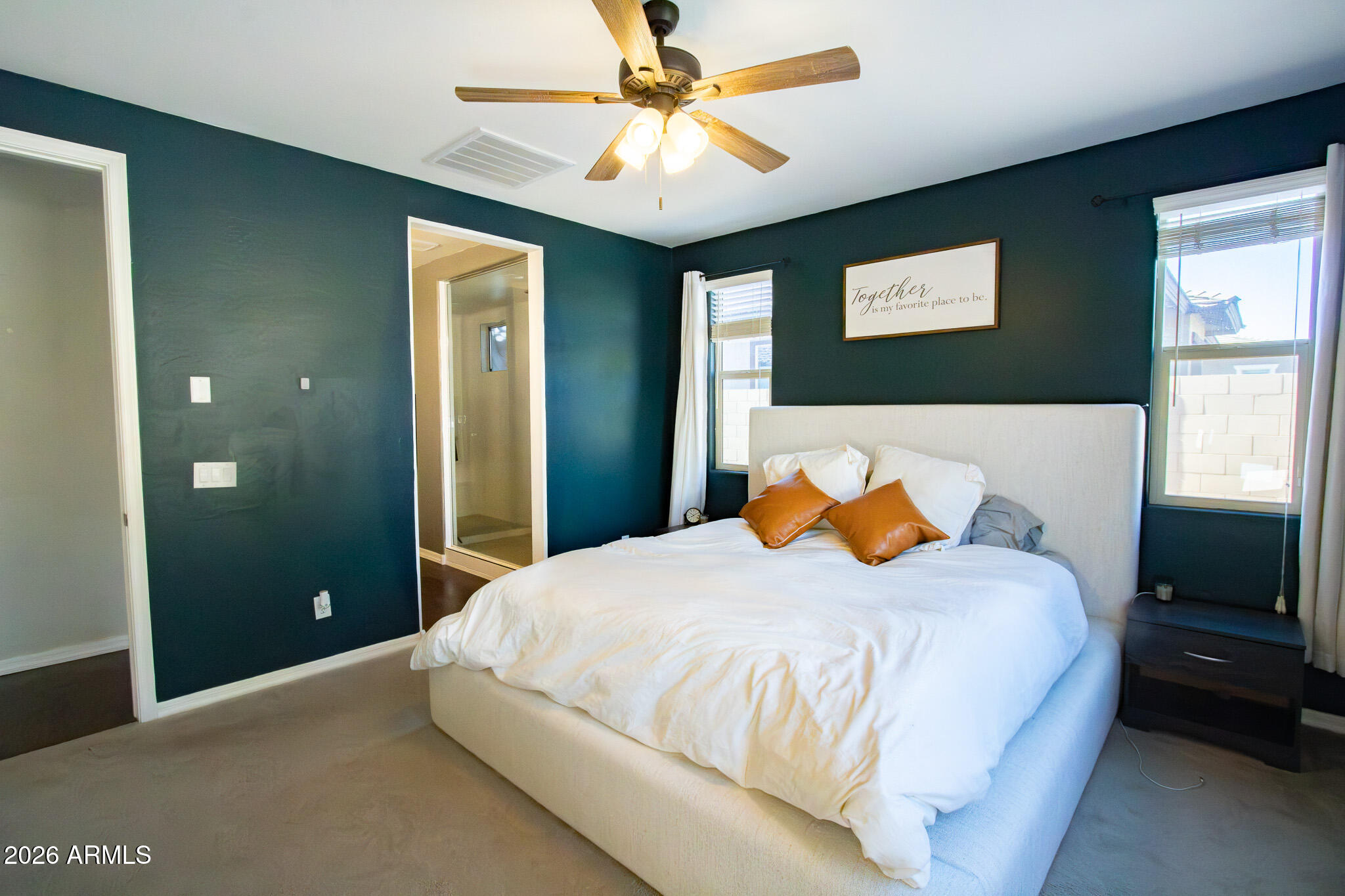 20378 West Maiden Lane Buckeye, AZ 85396 - Photo 24 of 41 a bedroom with a bed and a chandelier