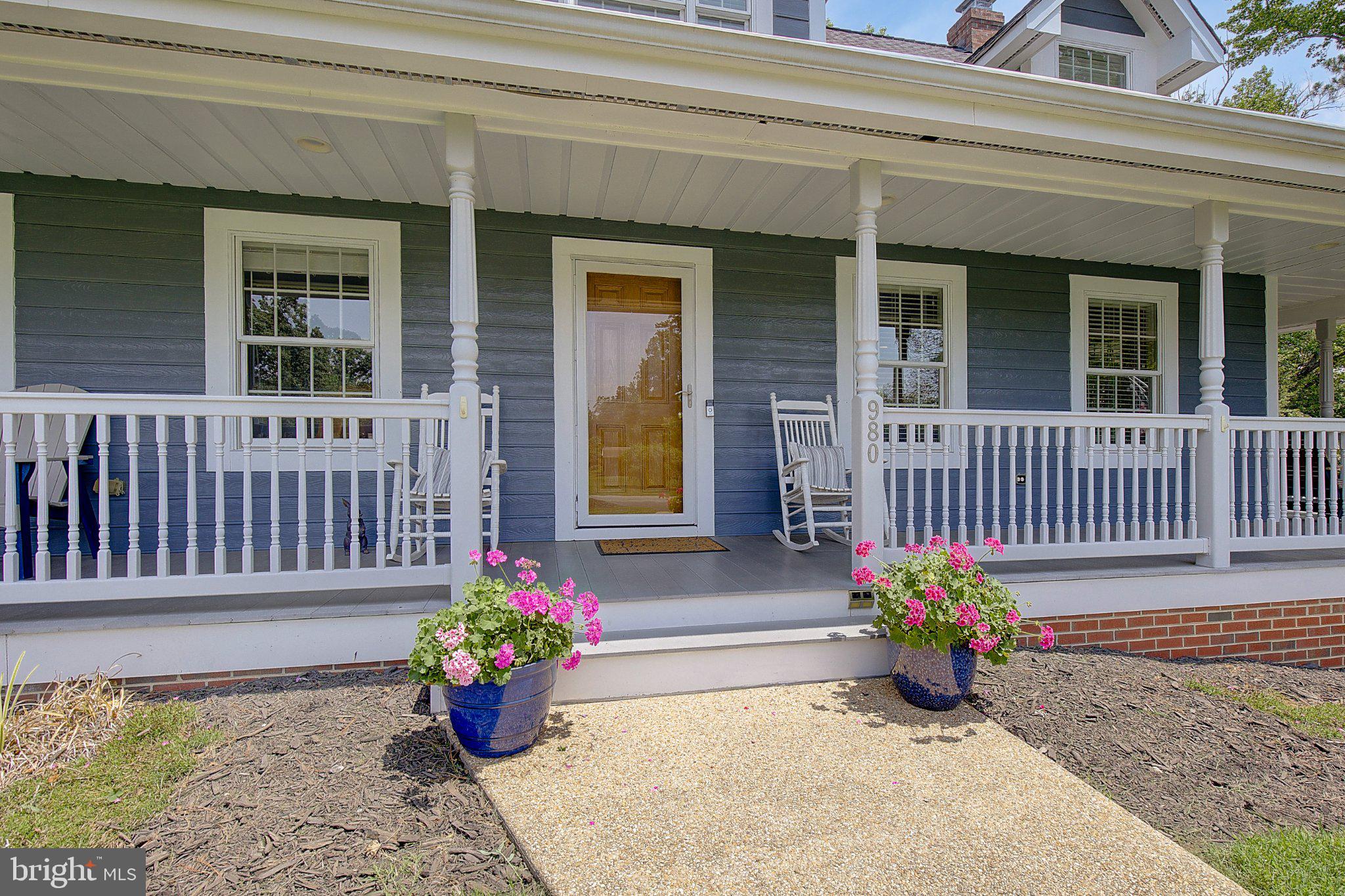 980 Apple Lane Solomons, MD 20629 - Photo 54 of 82 Charming porch with vibrant blooms.