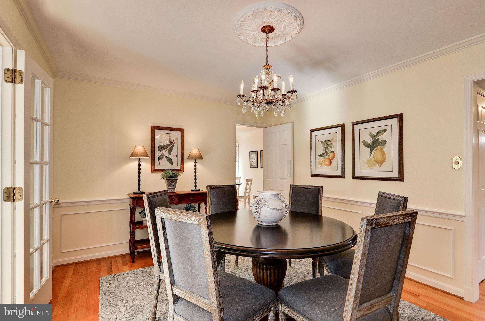 4904 Baltan Road Bethesda, MD 20816 - Photo 13 of 29 a view of a dining room with furniture and wooden floor