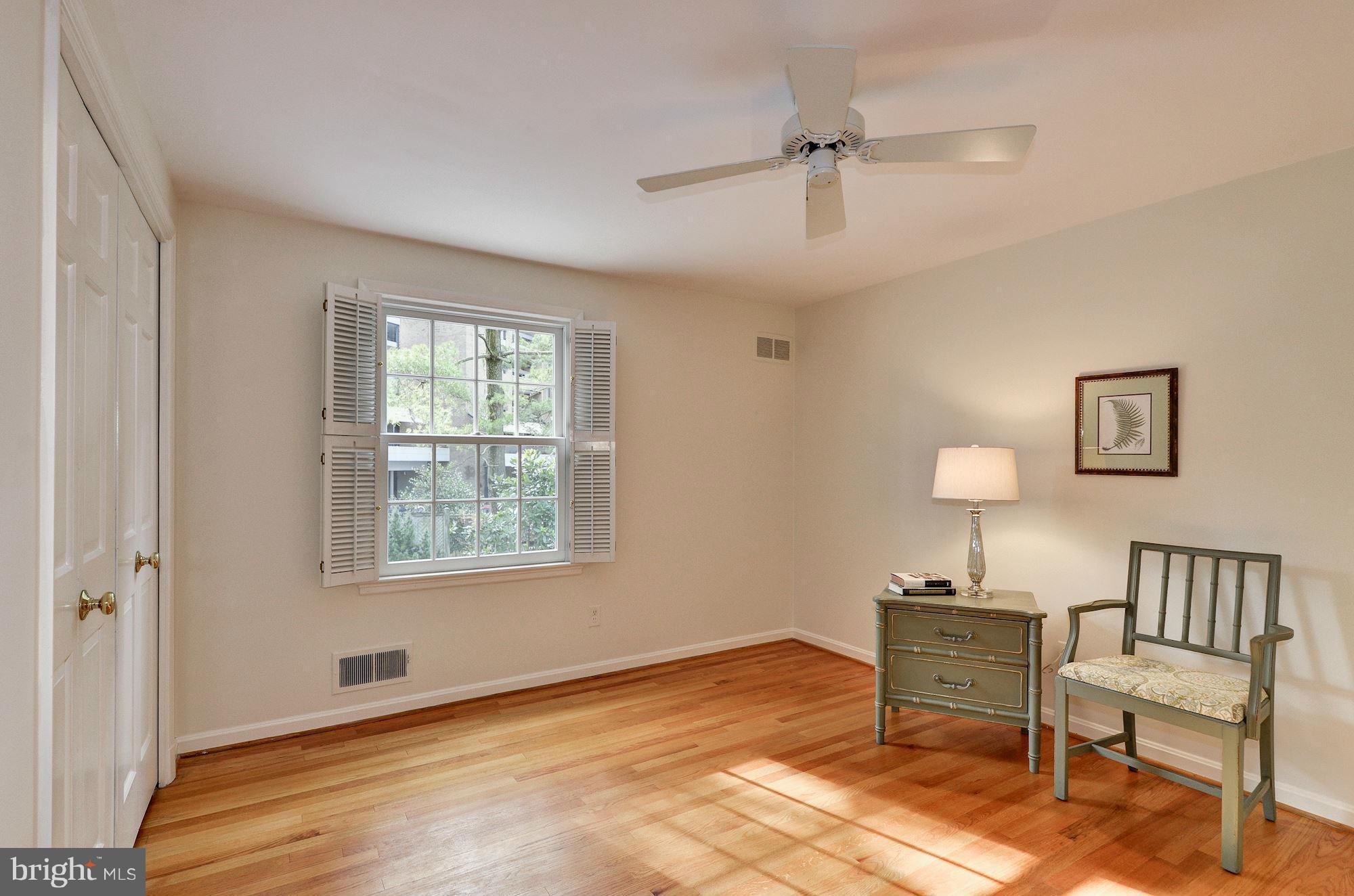 4904 Baltan Road Bethesda, MD 20816 - Photo 21 of 29 a view of an empty room with a window and a kitchen