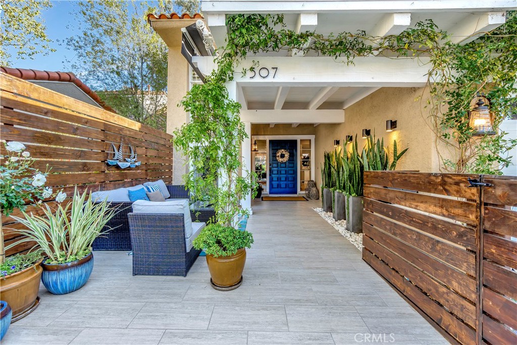 a view of a house with porch and potted plants