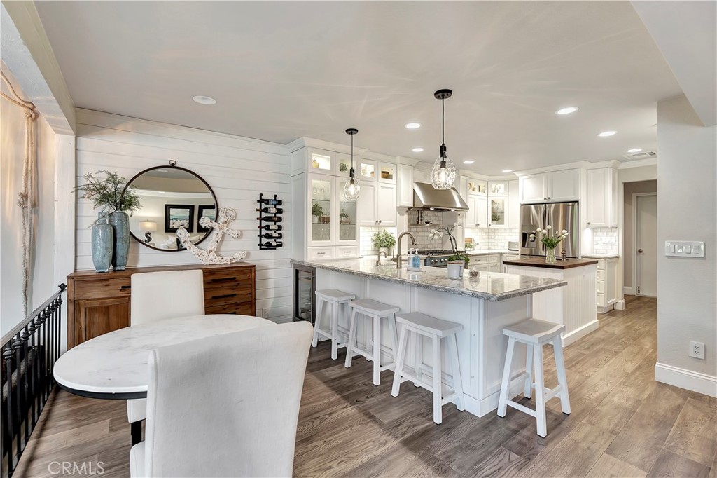 507 Cancha Newport Beach, CA 92660 - Photo 15 of 39 a kitchen with kitchen island stainless steel appliances a dining table chairs sink and cabinets
