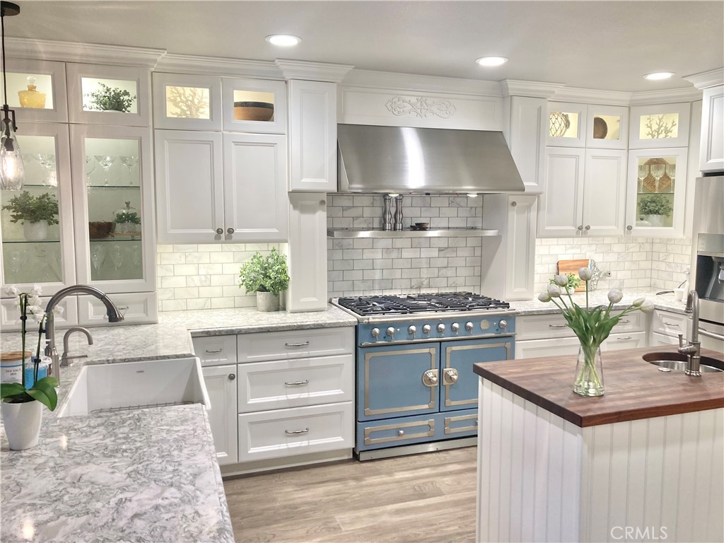 507 Cancha Newport Beach, CA 92660 - Photo 16 of 39 a kitchen with kitchen island granite countertop a stove and a sink