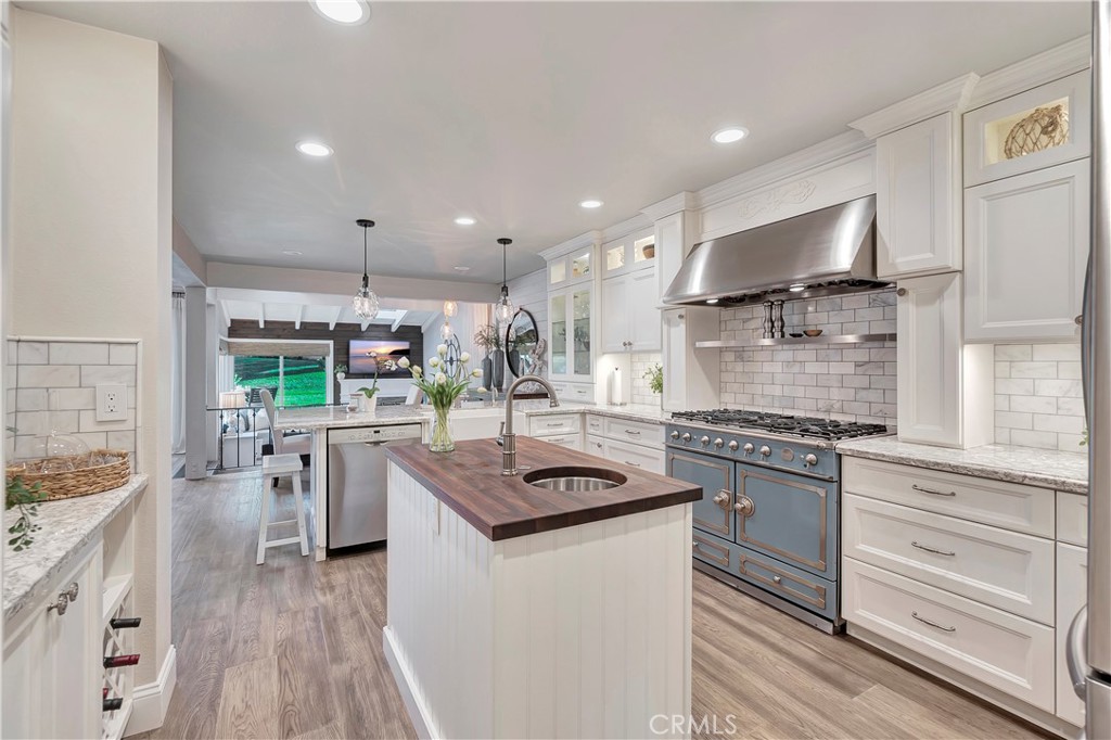 507 Cancha Newport Beach, CA 92660 - Photo 18 of 39 a kitchen with stainless steel appliances granite countertop a stove and a sink