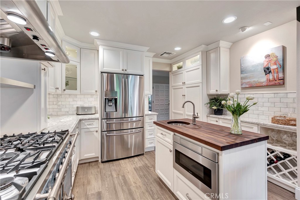 507 Cancha Newport Beach, CA 92660 - Photo 19 of 39 a kitchen with granite countertop a sink appliances and cabinets