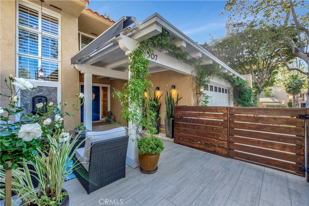 507 Cancha Newport Beach, CA 92660 - Photo 3 of 39 a front view of a house with potted plants