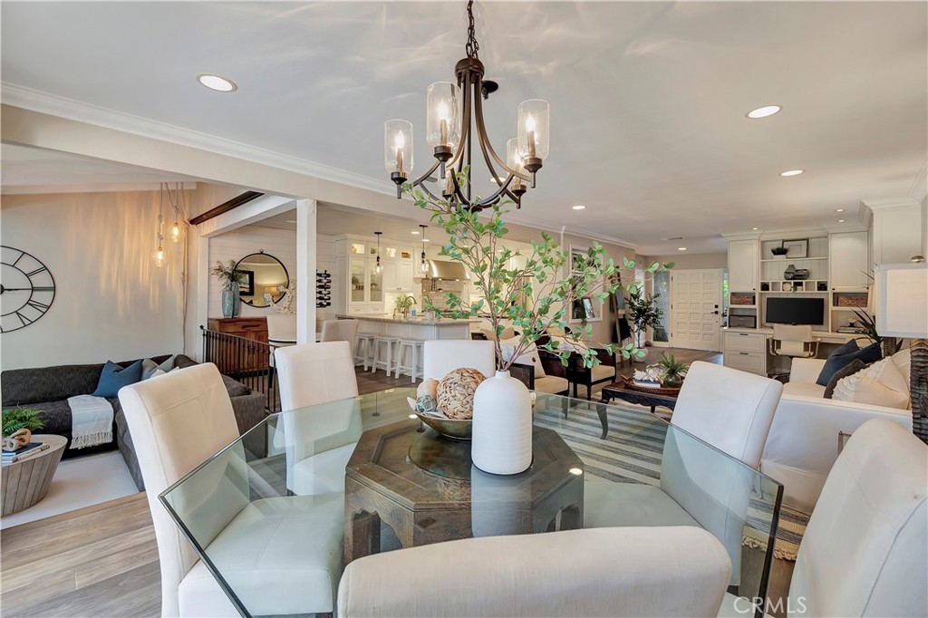 507 Cancha Newport Beach, CA 92660 - Photo 9 of 39 a view of a dining room with furniture a chandelier and wooden floor