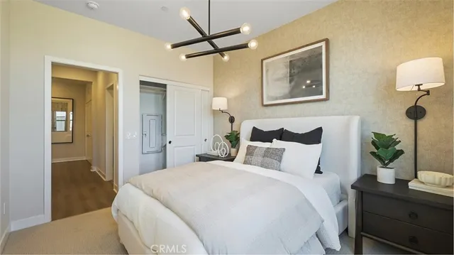 a bedroom with a bed and a lamp on table