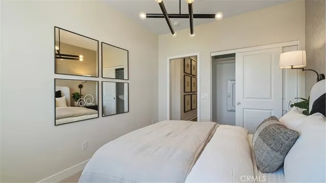 a bedroom with a bed and a mirror