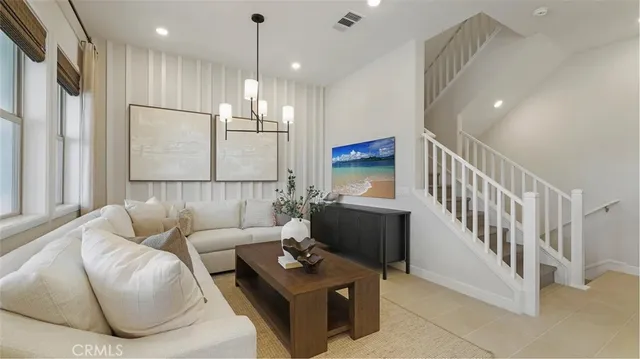 a living room with furniture and a chandelier