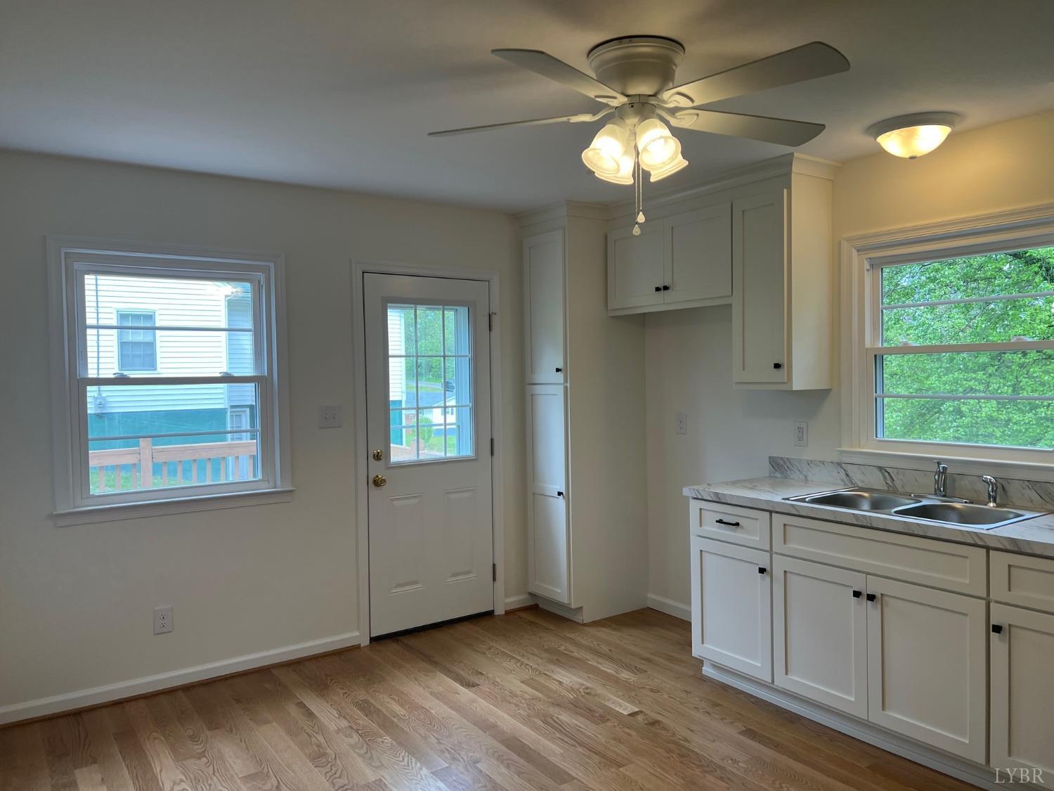 145 Church Street Amherst, VA 24521 - Photo 8 of 23 a kitchen with a white cabinets and window