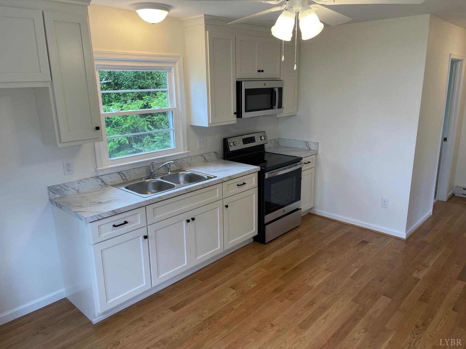 145 Church Street Amherst, VA 24521 - Photo 10 of 23 a kitchen with a sink cabinets and a window