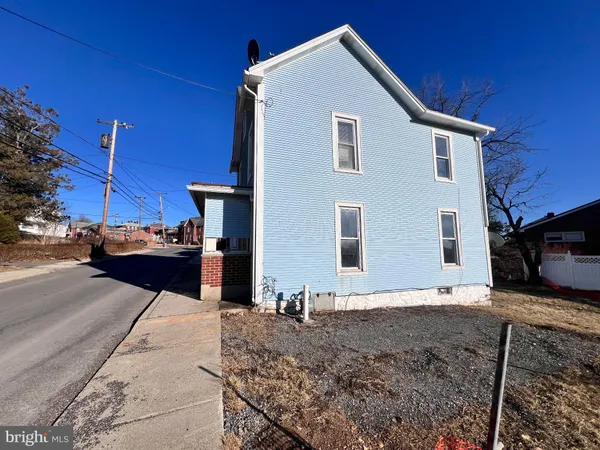 a front view of a house with parking area