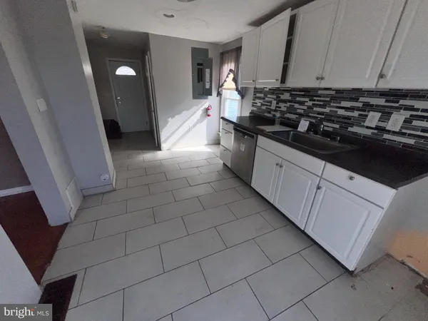 a kitchen with a sink and a stove