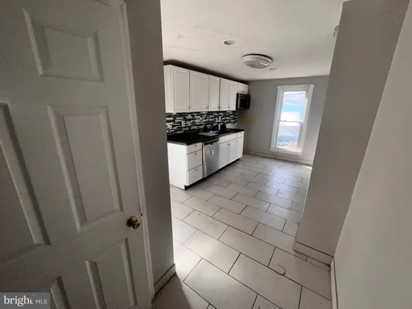 a kitchen with stainless steel appliances a refrigerator a stove a microwave and cabinets