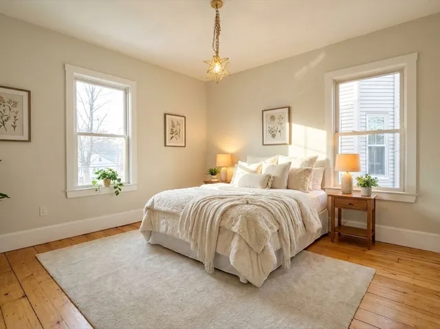 a spacious bedroom with a bed and a window