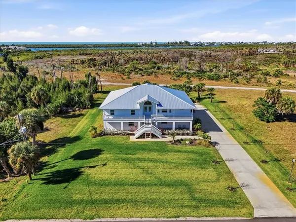 a aerial view of a house with big yard