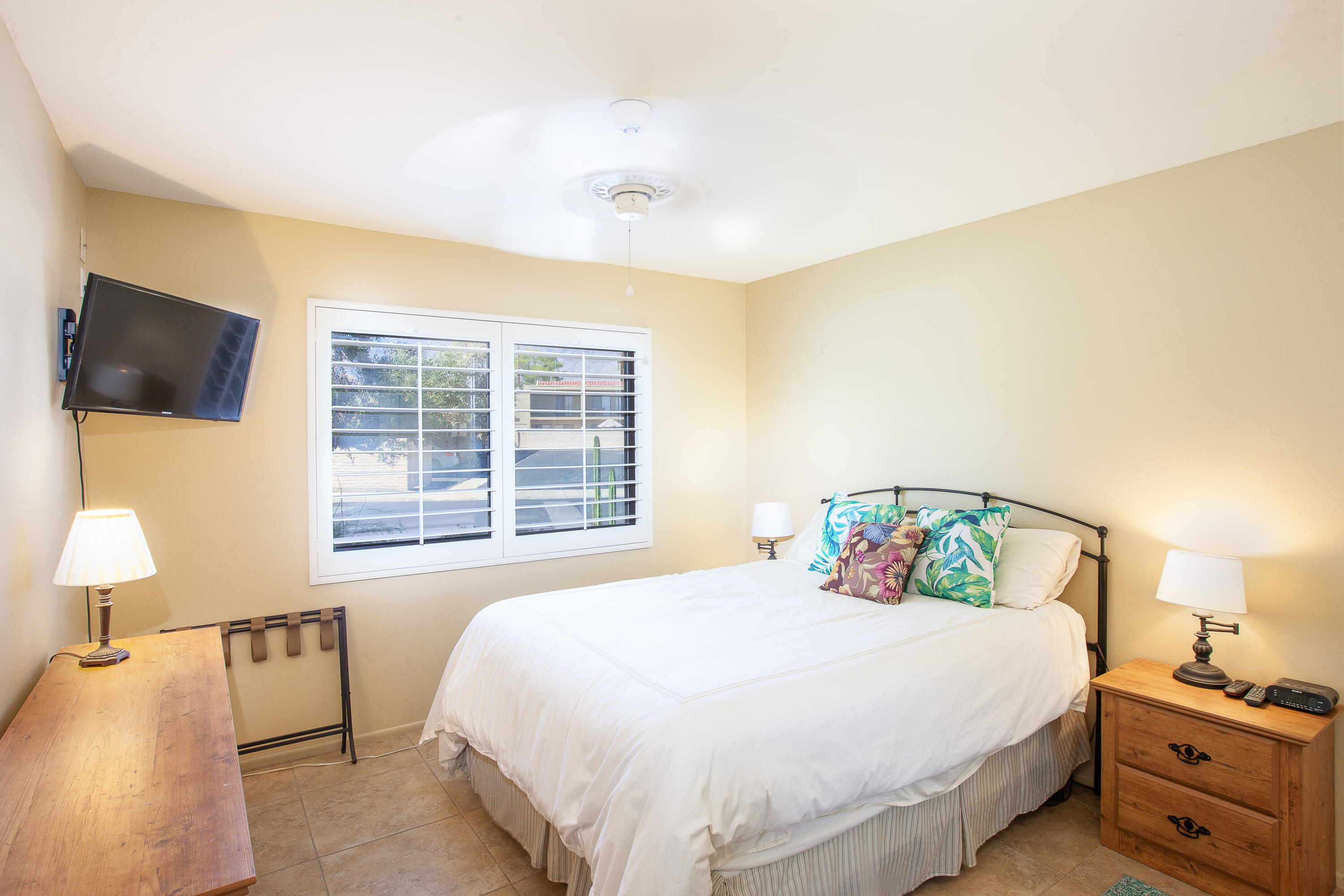 2348 Los Coyotes Drive Palm Springs, CA 92264 - Photo 13 of 15 a bedroom with a bed and a tv