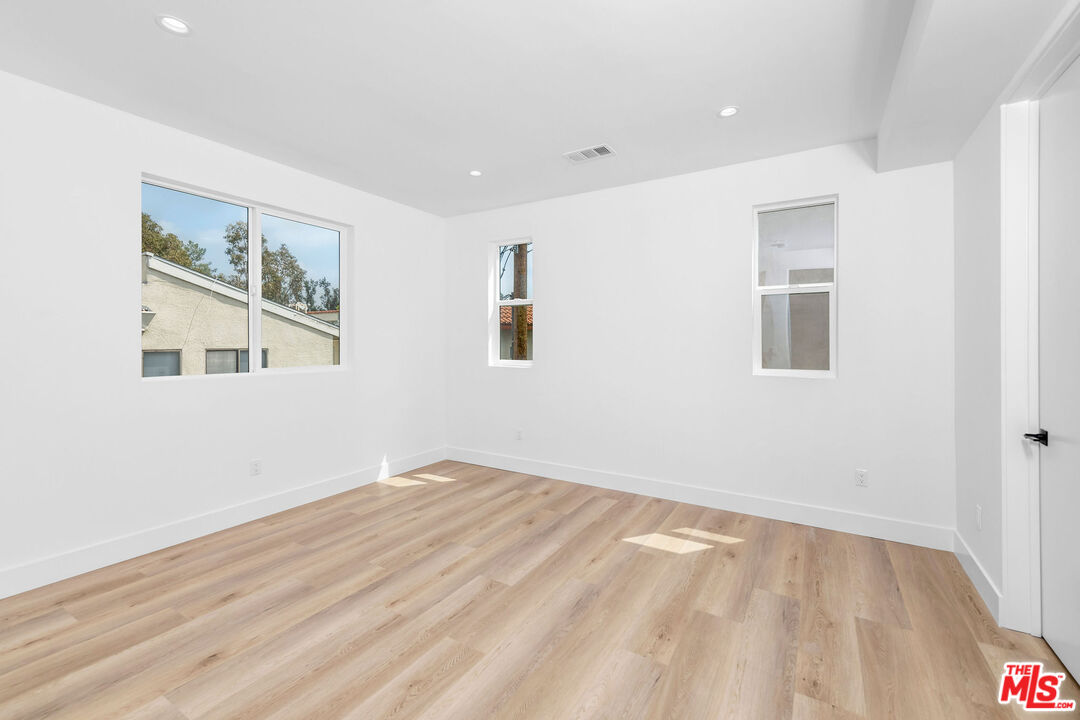 4337 Dixie Canyon Avenue Sherman Oaks, CA 91423 - Photo 14 of 22 a view of empty room with wooden floor and fan