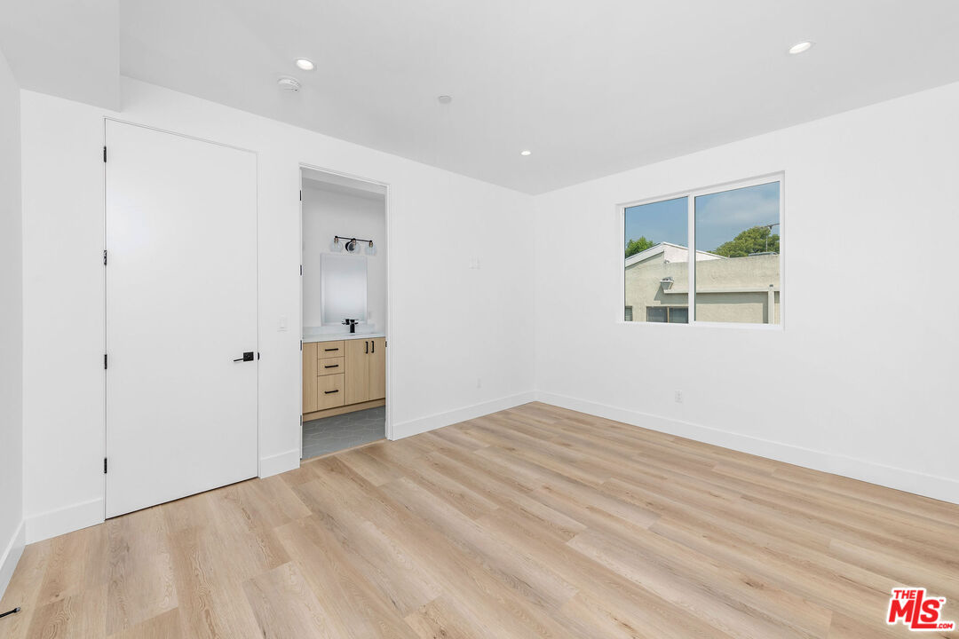 4337 Dixie Canyon Avenue Sherman Oaks, CA 91423 - Photo 15 of 22 a view of an empty room with wooden floor and a window
