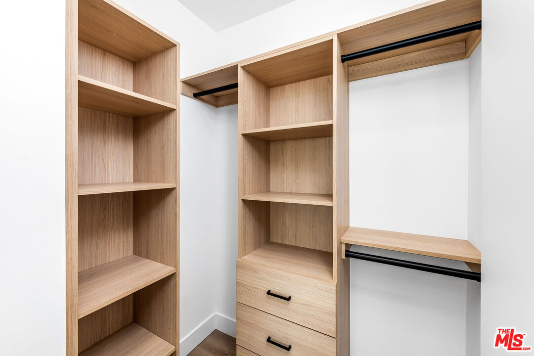 4337 Dixie Canyon Avenue Sherman Oaks, CA 91423 - Photo 16 of 22 a view of walk in closet with clothes and shoes
