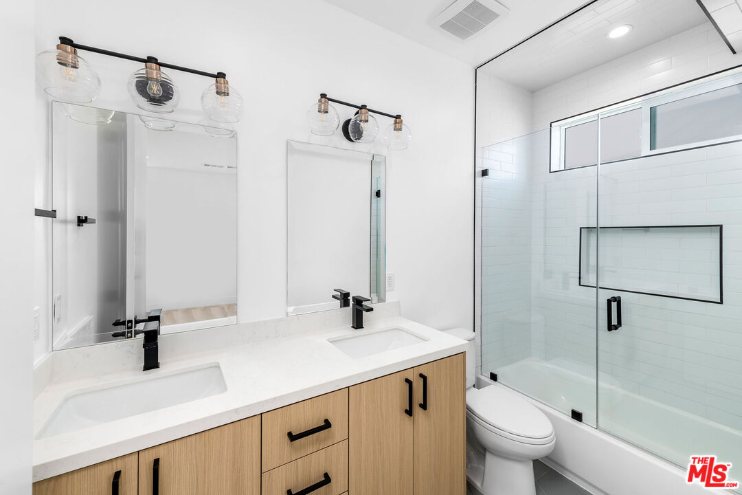 4337 Dixie Canyon Avenue Sherman Oaks, CA 91423 - Photo 17 of 22 a bathroom with a sink a toilet and a mirror