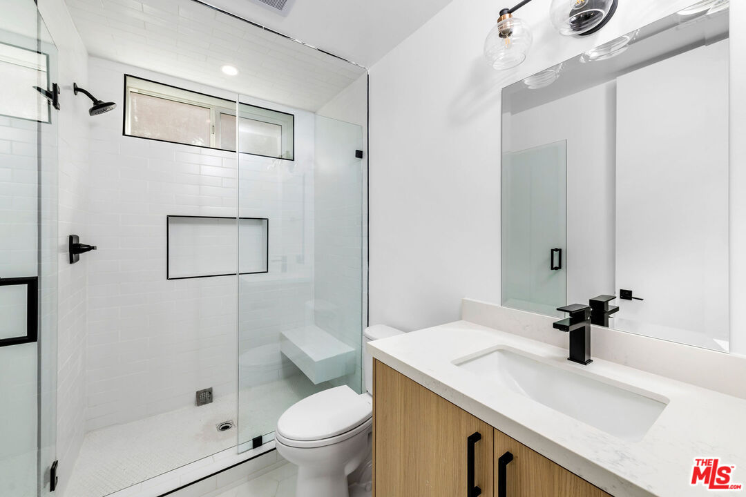 4337 Dixie Canyon Avenue Sherman Oaks, CA 91423 - Photo 7 of 22 a bathroom with a sink a toilet and shower