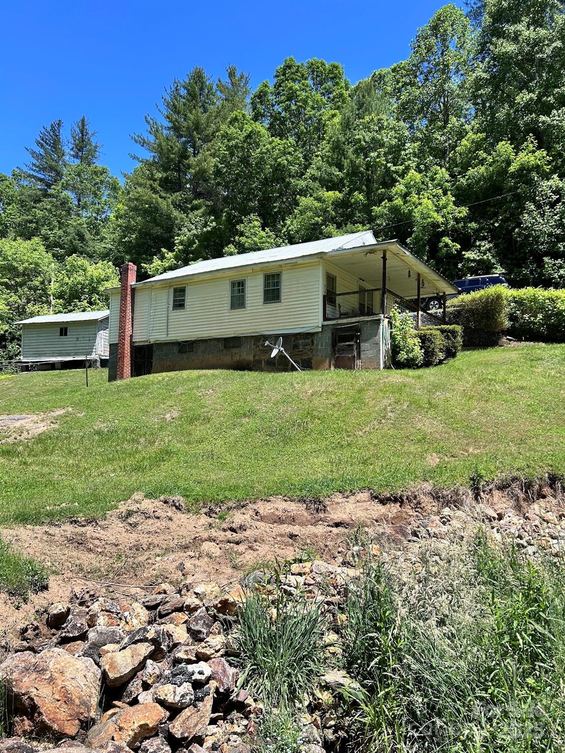 611 Johnson Hollow Road Bakersville, NC 28705 - Photo 21 of 43 a front view of a house with garden