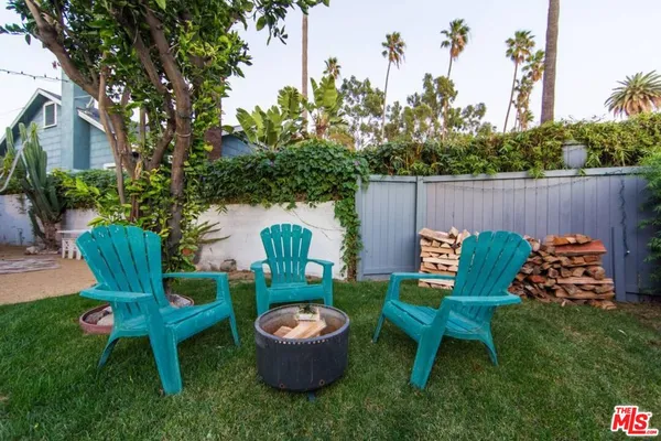 a view of a table and chairs in the back yard