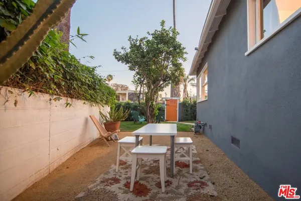 a view of a patio with table and chairs and potted plants