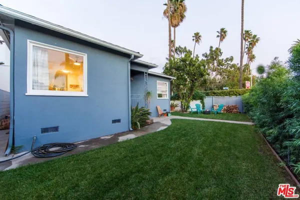 a view of an house with backyard space and garden