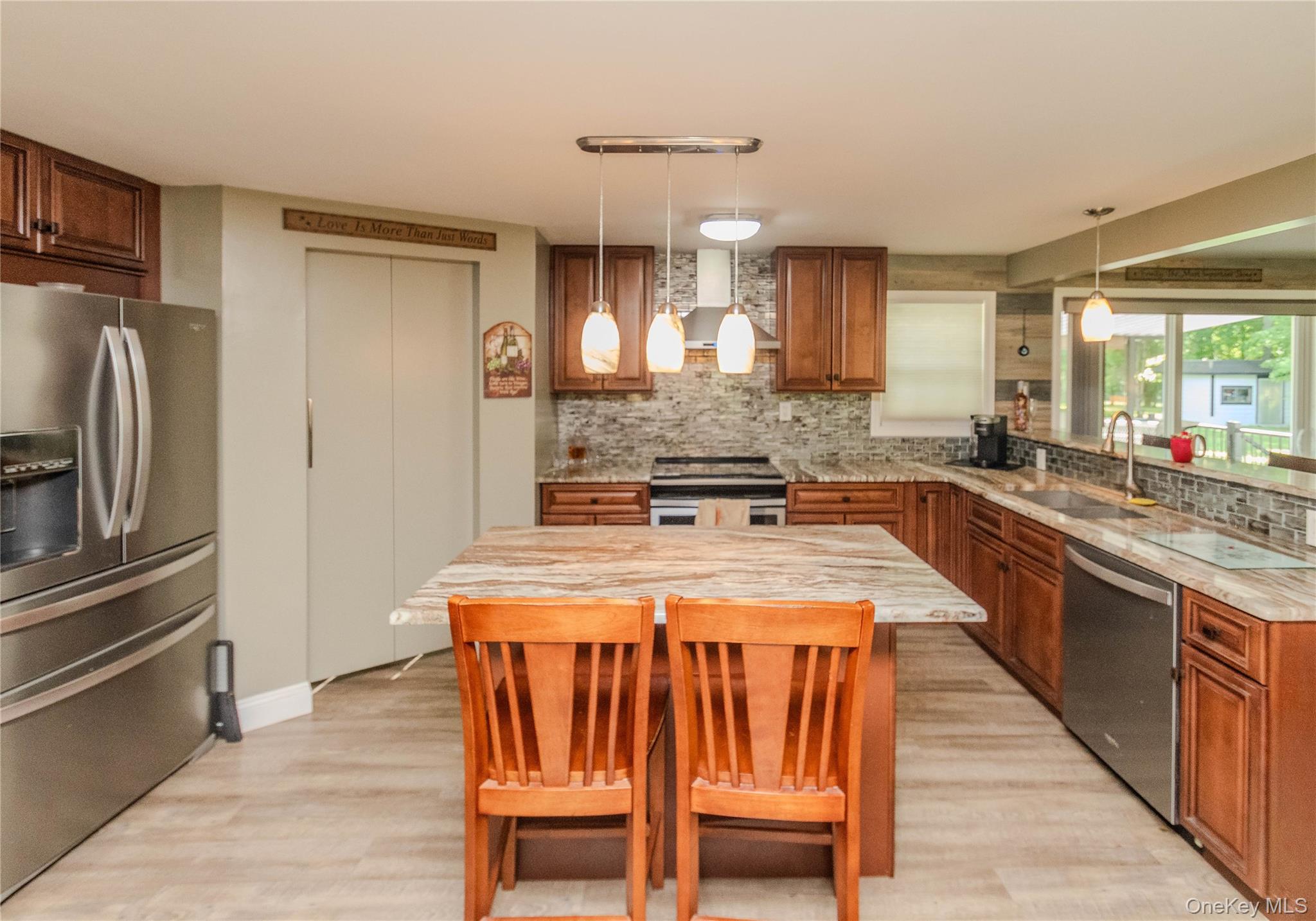 15 Van Dewark Road Middletown, NY 10941 - Photo 10 of 41 Kitchen featuring a large island with stone countertops, wood-finish flooring, stainless steel appliances, and wood cabinetry