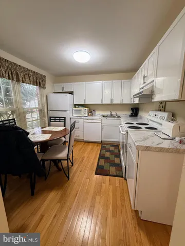 a kitchen with a sink appliances and cabinets