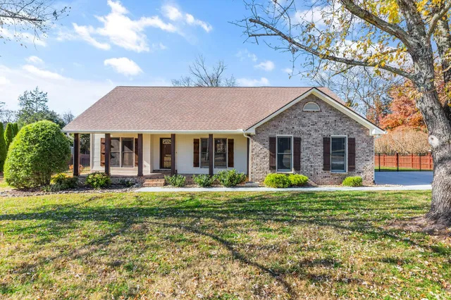 a front view of a house with a yard and porch