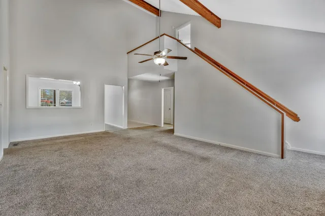 a view of a big room with closet and windows