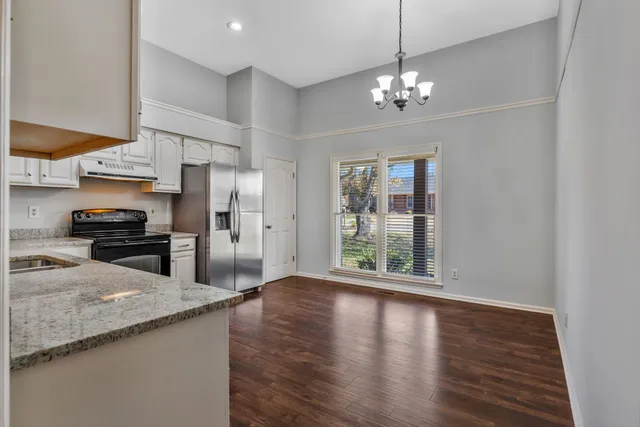 a kitchen with a refrigerator a sink and a stove