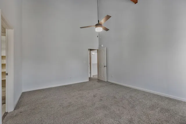 a view of empty room with ceiling fan
