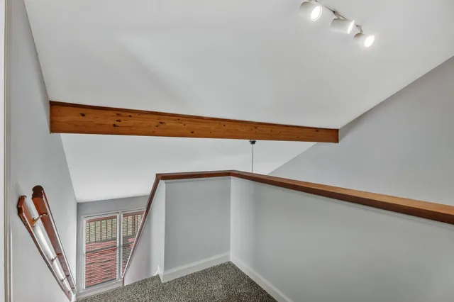 a view of an empty room with stairs