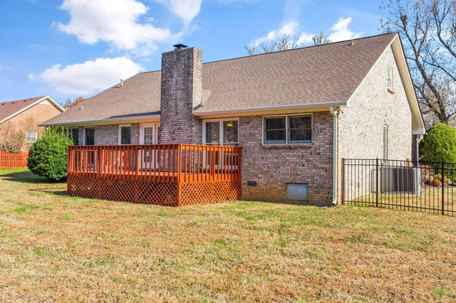 a view of house with large space and a yard
