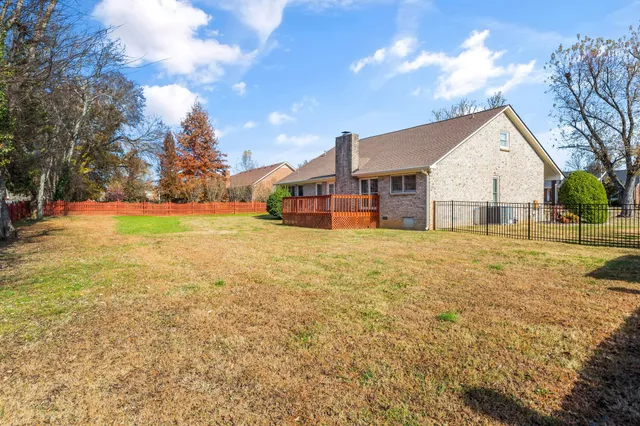 a view of a house with a yard and garage