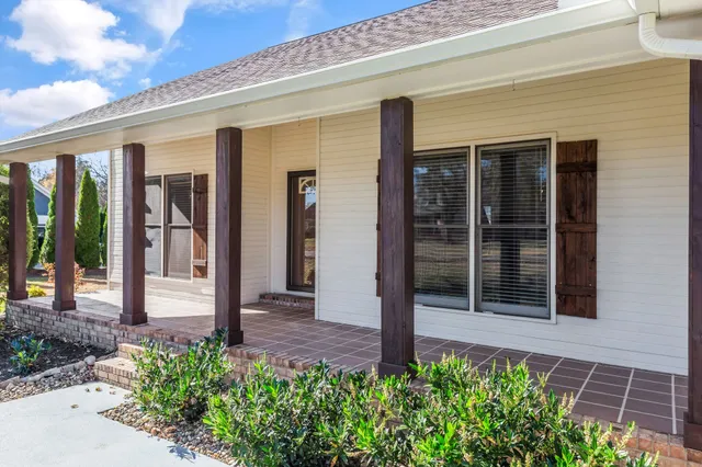 a front view of a brick house with a large windows