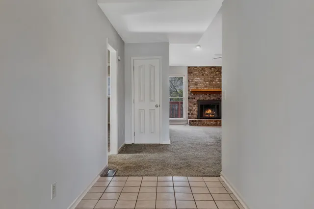 a view of an empty room and fire place