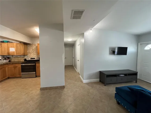 a view of kitchen with furniture and refrigerator