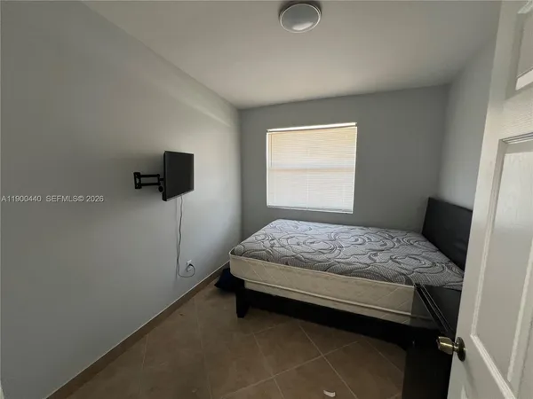 a bedroom with a bed and window