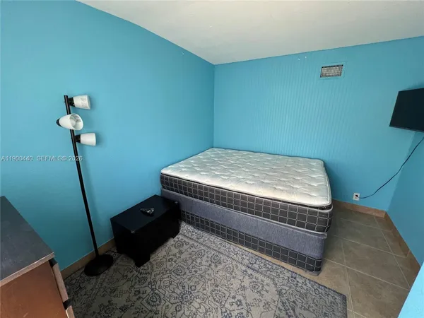 a bedroom with a bed and a tv