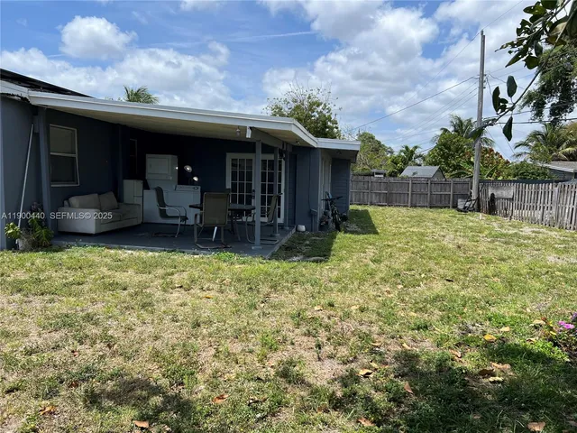 a view of a house with a backyard and porch